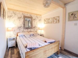 a bedroom with a bed and a mirror on the wall at Chalet Forte in Aberdyfi