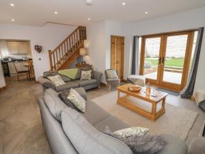 a living room with two couches and a table at The Stables in Bromsgrove