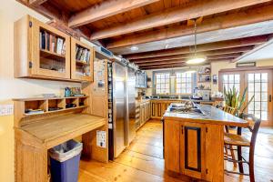 a kitchen with wooden cabinets and a refrigerator at Mad River SpaCasa in Waitsfield