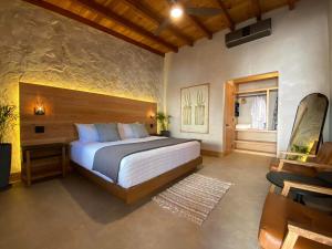 a bedroom with a large bed and a window at MYA Hotel Boutique in Valle de Guadalupe