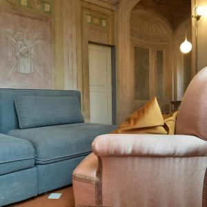 a living room with a couch and a chair at Palazzo Capponi in Florence