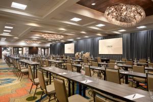 a conference room with tables and chairs and a projection screen at Omni Hilton Head Oceanfront Resort in Hilton Head Island