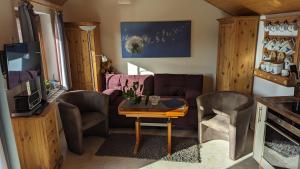 a living room with a couch and a table at Ferienhaus Manoury am Klosterbrunnen in Waldeck