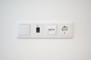 a white light switch on a white wall at Social Lodge - Piornais in Funchal