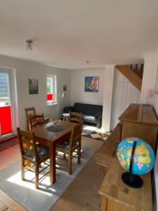 a living room with a table and chairs at Sofort am Strand! in Kiel