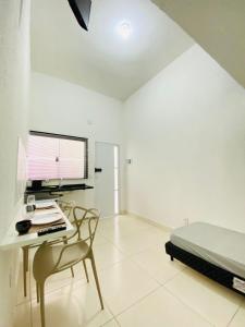a bedroom with a desk with a computer and a bed at DuPai Sorocaba in Sorocaba
