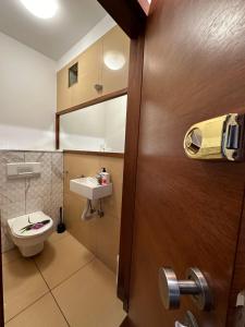 a bathroom with a toilet and a sink at Pokoje Centrum/ rooms in Centre in Warsaw