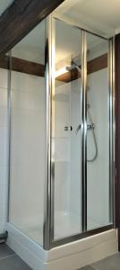 a shower with a glass door in a bathroom at HÔTEL ROYAL MONTREUIL in Montreuil