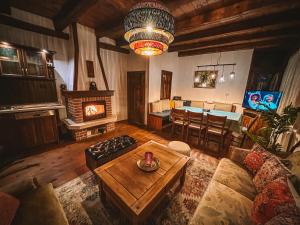 a living room with a couch and a table at Кътче in Leshten