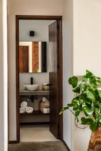 a bathroom with a sink and a mirror at La Barra Resorts Puerto Escondido in Puerto Escondido