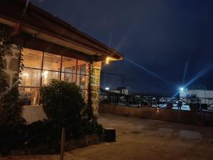 a building with a view of the ocean at night at Hotel Brisas del Quisco in El Quisco