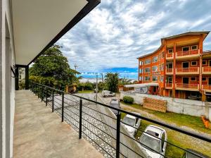 a balcony of a building with a view of a street at Otimo flat a beira mar na Praia de Guaratuba SP in Bertioga