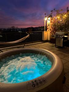 a jacuzzi tub on the roof of a building at Spazio Prestige in Milan