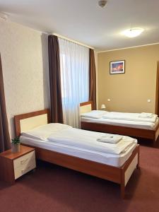 Postel nebo postele na pokoji v ubytování Hotel 21