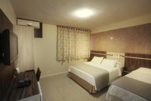 Postel nebo postele na pokoji v ubytování Hotel Real