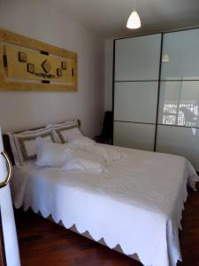 - une chambre avec un lit doté de draps et d'oreillers blancs dans l'établissement Marco Romani, à Pérouse