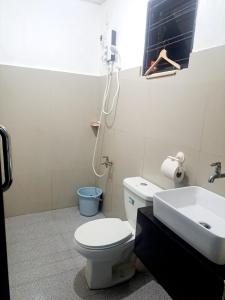 a bathroom with a toilet and a sink at Hundred Islands lucky One Transient 3mins walk fr wharf in Alaminos