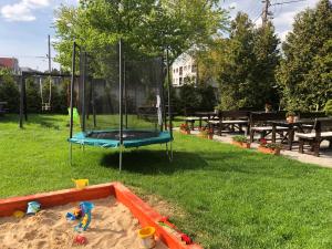 a sandbox with a swing in the sand in a park at Hotel 21 in Bratislava