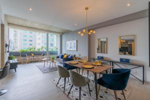 a dining room and living room with a table and chairs at Beautiful Apt in Santa Fe with Panoramic Views! in Mexico City