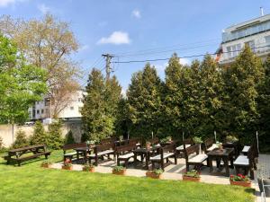 a group of benches and tables in a park at Hotel 21 in Bratislava