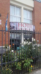 a hotel with a sign in front of a building at avellaneda suites in R&iacute;o Gallegos
