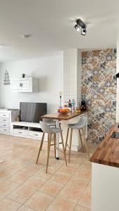 a kitchen with a table and chairs and a television at Boutique Apartment Adeje I in Adeje