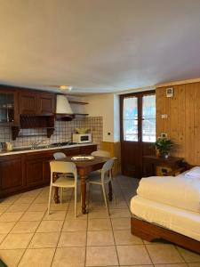 a kitchen and living room with a table and chairs at Baita Reale in Alagna Valsesia