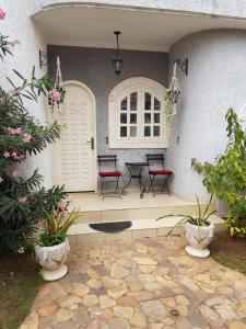 a patio with two chairs and a table in a house at The Manor in Lomé