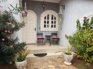 a porch with chairs and plants in a house at The Manor in Lomé