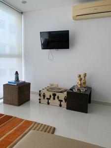 un soggiorno con TV a schermo piatto a parete di Apartamento Cerca Al Hotel Las Américas a Cartagena de Indias