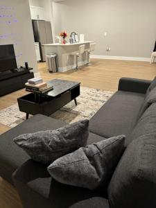 a living room with a couch and a coffee table at Towson Elite Apartment in Towson