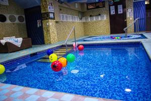 a large swimming pool with colorful balls in it at Azul Turquesa in Cuernavaca