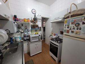 a small kitchen with a stove and a microwave at SuhcasaCopacabana 48 Spacious in Rio de Janeiro