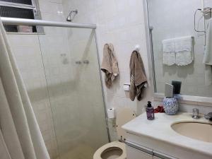a bathroom with a shower and a toilet and a sink at SuhcasaCopacabana 48 Spacious in Rio de Janeiro