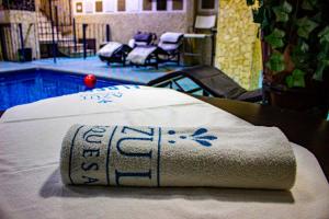 a towel sitting on a table next to a pool at Azul Turquesa in Cuernavaca