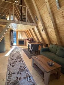 a living room with a couch and a table at Cottage Rioni Kutaisi in Kutaisi