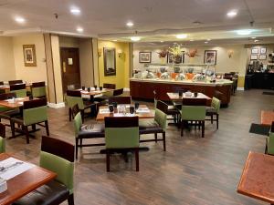 a restaurant with tables and chairs and a buffet at Radisson Hotel Philadelphia Northeast in Trevose
