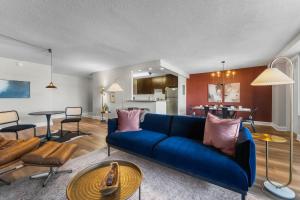 a living room with a blue couch and a table at Chic DC Getaway Near Metro in Arlington