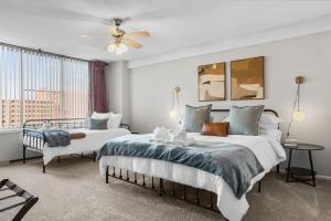 a bedroom with two beds and a ceiling fan at Chic DC Getaway Near Metro in Arlington