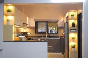 a kitchen with potted plants on the shelves at UnnisHome in Adūr