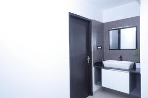 a bathroom with a white sink and a mirror at UnnisHome in Adūr +30 photos