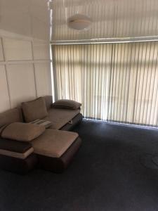 a living room with a couch and a window at Fast book Homes. Close to Uni in Hull