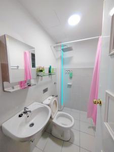 a bathroom with a sink and a toilet and a shower at QM Homestay in Semenyih