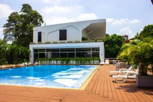 a swimming pool in front of a house at Hotel Blue 66 in Cali