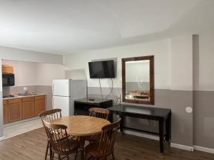 a small kitchen with a table and a dining room at Sea Palace Motel in Seaside Heights