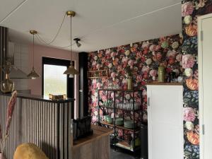 a kitchen with a flowery wallpaper on the wall at Hubanet in Giethoorn