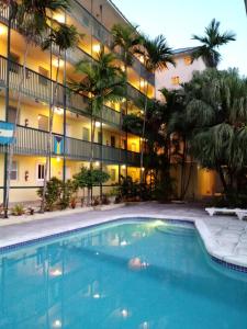a large swimming pool in front of a building at Apartment in downtown at the beach in Nassau