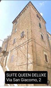 a large brick building with the words suite queen dellevia san gregorio at CHARME in Civita Castellana