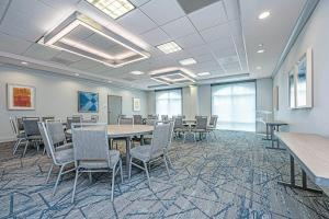 a conference room with a table and chairs at Holiday Inn Express and Suites North Charleston, an IHG Hotel in Charleston