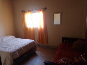 a bedroom with a bed and a window at Paz y Eva in Salta